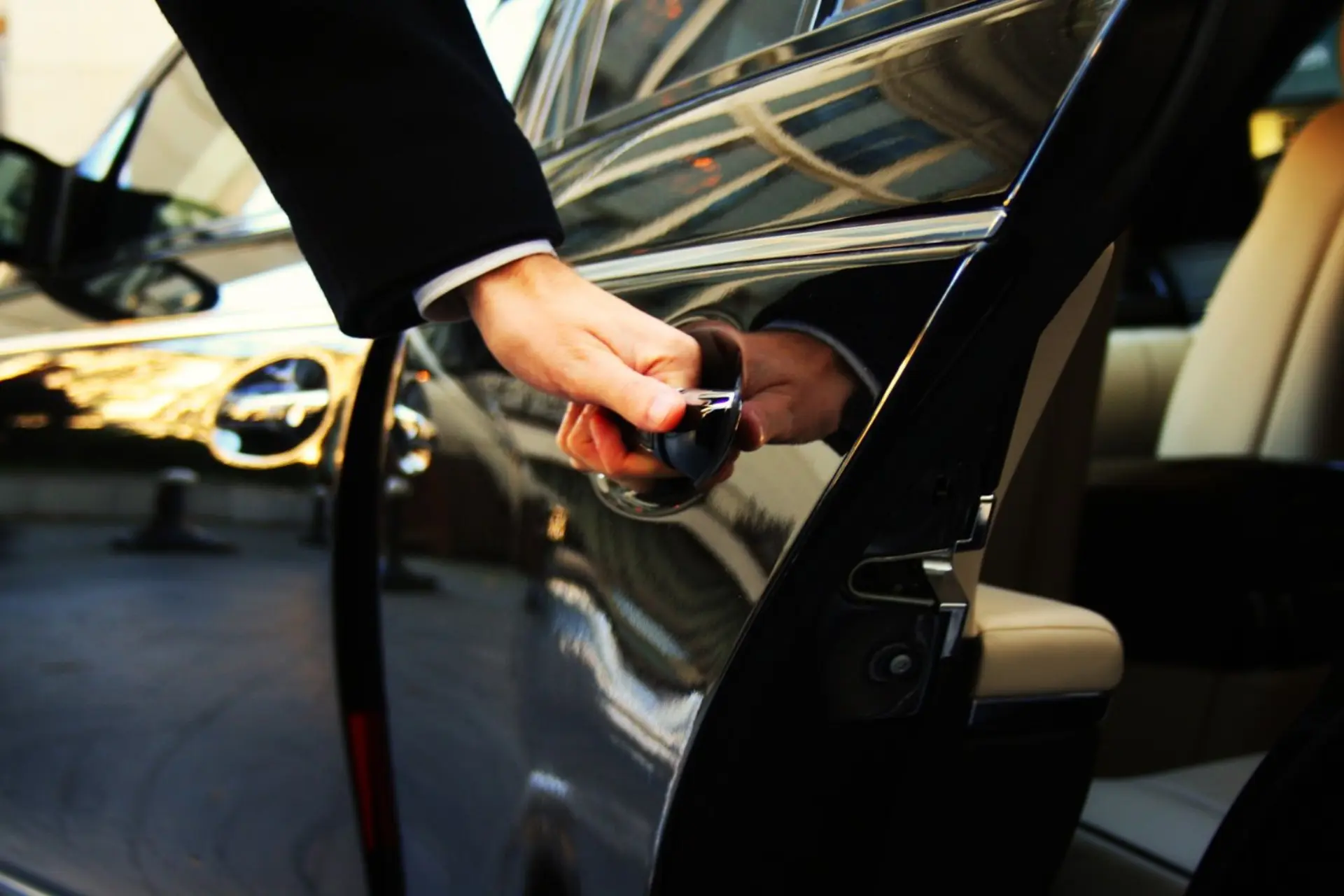 Professional chauffeur opening car door — O'Hare Limo Express O'Hare and Midway airport transfers