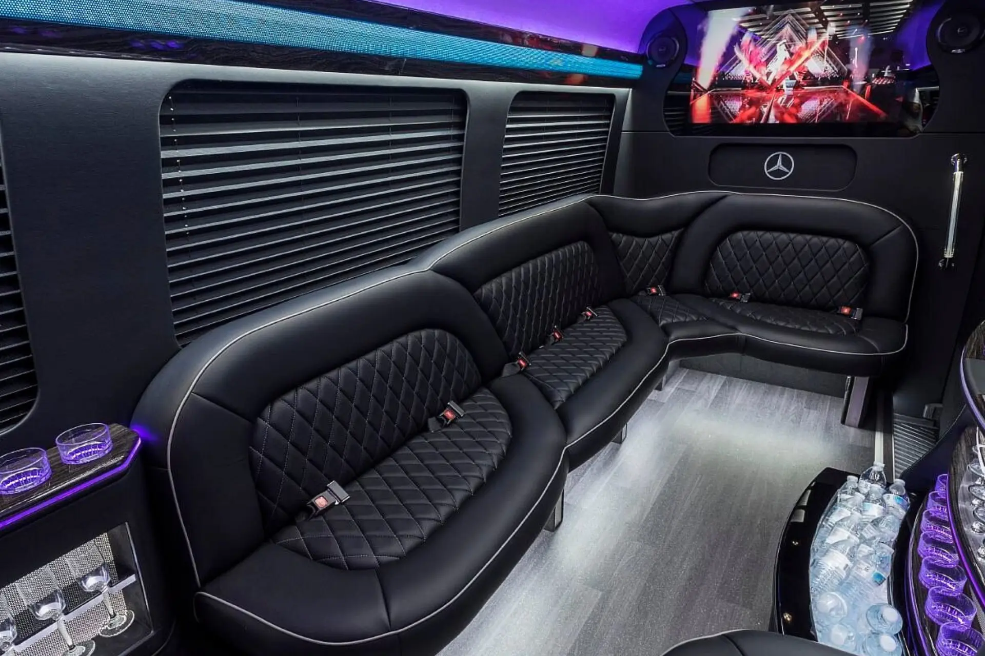 Luxury Mercedes Sprinter party bus interior — LED mood lighting, premium leather seating, and sound system for Elgin events